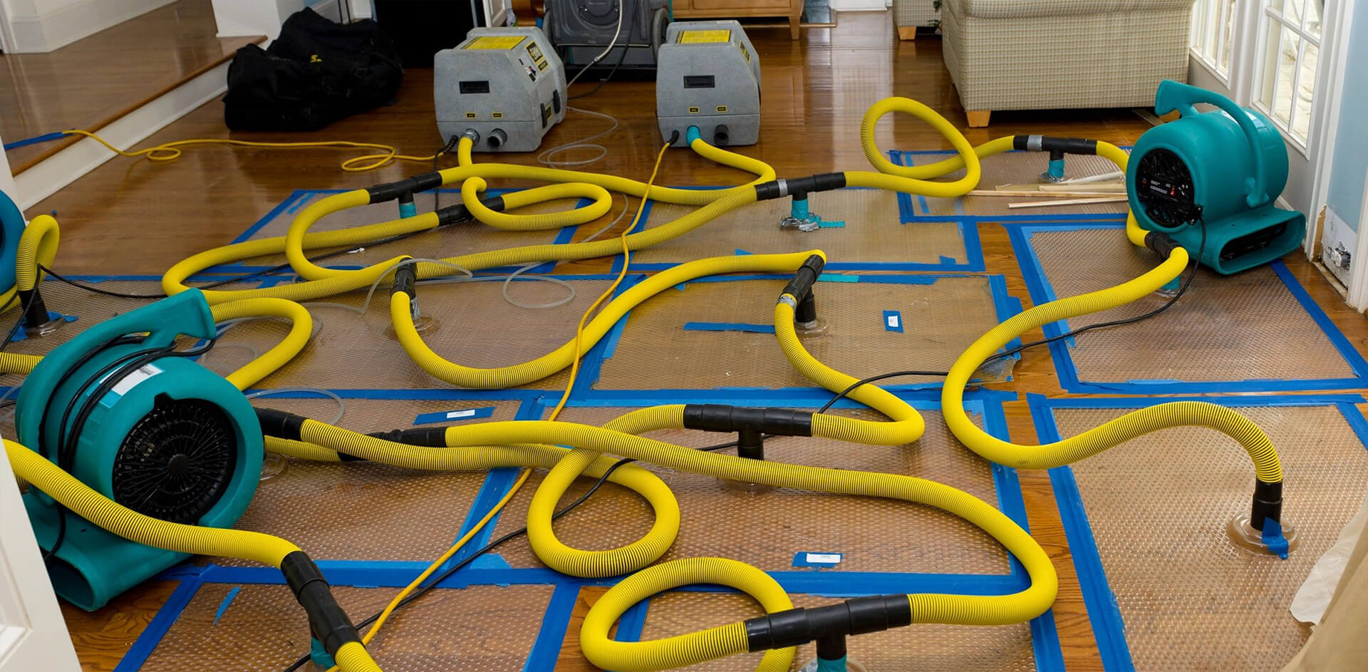 A bunch of yellow hoses are laying on the floor