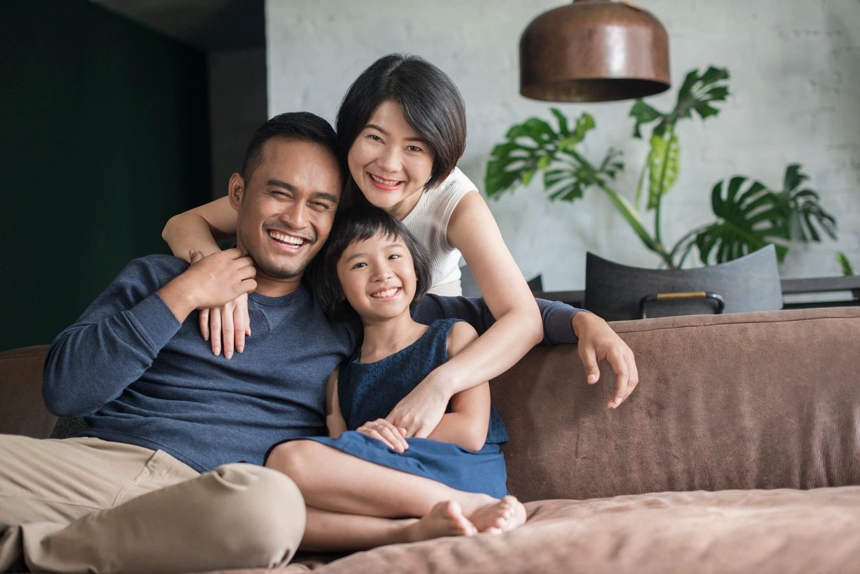 A family sitting on the couch together